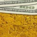 One hundred dollar banknotes on golden surface background close up. Royalty Free Stock Photo