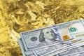 One hundred dollar banknotes stack on gold mine close up. Mining industry concept with dollars and gold Royalty Free Stock Photo