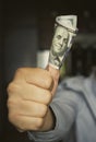one hundred dollar bill. Young man holding money with thumbs up Royalty Free Stock Photo