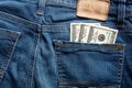 One hundred dollar bills in the back pocket of a blue jean. Royalty Free Stock Photo