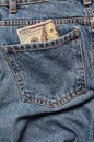 One hundred dollar bills in the back pocket of the rumpled jeans. Royalty Free Stock Photo