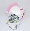 One hundred dollar bills falling out of a white piggy bank with pink ears and tutu Royalty Free Stock Photo