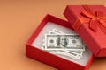 One hundred dollar bills in a red gift box Royalty Free Stock Photo