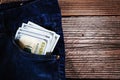 A one hundred dollar notes in the front pocket of denim trousers Royalty Free Stock Photo