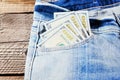 A one hundred dollar notes in the front pocket of denim trousers Royalty Free Stock Photo