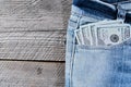 A one hundred dollar notes in the front pocket of denim trousers Royalty Free Stock Photo