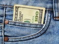One hundred dollars bill in the pocket of blue jeans close up Royalty Free Stock Photo