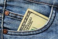 One hundred dollars bill in the pocket of blue jeans close up Royalty Free Stock Photo