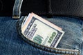 One hundred dollars bill sticking out of the blue jeans pocket Royalty Free Stock Photo