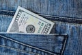 Pile of one hundred american dollar banknotes in the back jeans pocket. Close up one hundred US Dollar as symbol of poverty and Royalty Free Stock Photo