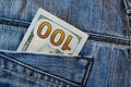 Pile of one hundred american dollar banknotes in the back jeans pocket. Close up one hundred US Dollar as symbol of poverty and Royalty Free Stock Photo