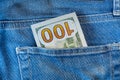 Pile of one hundred american dollar banknotes in the back jeans pocket. Close up one hundred US Dollar as symbol of poverty and Royalty Free Stock Photo