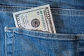 Pile of one hundred american dollar banknotes in the back jeans pocket. Close up one hundred US Dollar as symbol of poverty and Royalty Free Stock Photo