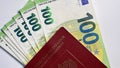 One hundred euro cash notes. The single currency of the European Union. 100 euro banknotes are enclosed in the passport of the Royalty Free Stock Photo