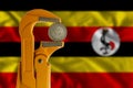 One hundred shillings Uganda coin and Plumber wrench
