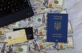 One hundred US dollars as money a laptop computer on buying a ticket online with using credit card on Ukrainian passport Royalty Free Stock Photo