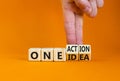 One idea and action symbol. Concept words One idea and One action on wooden cubes. Businessman hand. Beautiful orange table orange Royalty Free Stock Photo