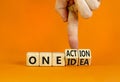 One idea and action symbol. Concept words One idea and One action on wooden cubes. Businessman hand. Beautiful orange table orange Royalty Free Stock Photo