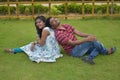 One Indian married couple sitting on the grass and enjoying their time together. concept of love and outing