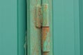 One iron green door hinge in rust on a metal gate Royalty Free Stock Photo