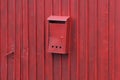 One iron mail box hanging on a red metal fence Royalty Free Stock Photo