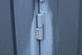One iron old gray door hinge on a metal gate Royalty Free Stock Photo