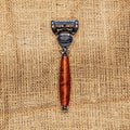 One iron and wooden razor on the canvas. View from above Royalty Free Stock Photo