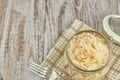 One jar of sauerkraut and carrots in its own juice with spices on a light, white wooden table, top view of the cabbage in the jar Royalty Free Stock Photo