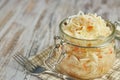 One jar of sauerkraut and carrots in its own juice with spices on a light, white wooden table, a vertical kind of cabbage in a jar Royalty Free Stock Photo