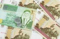 A one Jordanian dinar on a background of Russian one hundred ruble bank notes