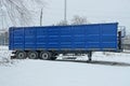 One large blue metal trailer container on black wheels Royalty Free Stock Photo