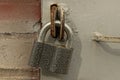 One large closed iron padlock hanging on a gray metal door Royalty Free Stock Photo