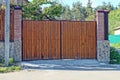 One large closed wooden gate made of brown planks