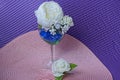 One large glass goblet with white artificial flowers roses and blue stones Royalty Free Stock Photo