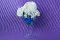 One large glass goblet with white artificial flowers roses Royalty Free Stock Photo