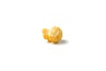 One large grain of yellow delicious roasted popcorn lies on a white background Royalty Free Stock Photo