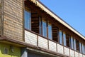 Large wooden brown balcony porch with windows against a blue sky Royalty Free Stock Photo