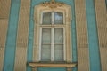 Large retro window on a blue gray building wall