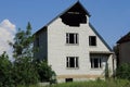 one large white brick house with an unfinished attic and empty windows Royalty Free Stock Photo