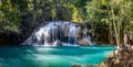 One of the largest waterfalls in Erawan National park in Thailand has a aqua pool with some fish