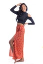 One leg slightly raised through the skirt. Afrodescendant woman