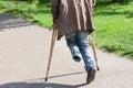 The one-legged disabled person walks in park on crutches