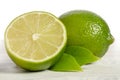 One lemon with half of juicy lime on wooden table Royalty Free Stock Photo