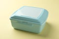 One light blue lunch box on beige background Royalty Free Stock Photo