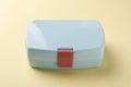 One light blue lunch box on beige background Royalty Free Stock Photo