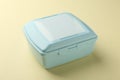 One light blue lunch box on beige background Royalty Free Stock Photo