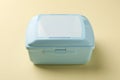 One light blue lunch box on beige background Royalty Free Stock Photo