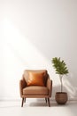 One light brown armchair with a pillow in the living room on a white background, next to a green plant in a pot. Cozy Royalty Free Stock Photo