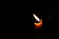 One light candle burning brightly, image is isolated against a b Royalty Free Stock Photo