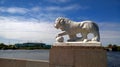 One of the lion sculptures on Elagin island with the stadium Saint Petersburg in the background